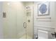 Clean bathroom with a walk-in shower, toilet, and decorative artwork at 30 W Palm Ln, Phoenix, AZ 85003