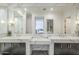 Luxurious bathroom with double vanity, marble countertop and large mirrors at 30 W Palm Ln, Phoenix, AZ 85003