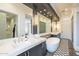 Modern bathroom with double vanity and free-standing tub at 30 W Palm Ln, Phoenix, AZ 85003