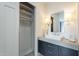 Stylish bathroom with dark vanity, patterned floors, and a large mirror at 30 W Palm Ln, Phoenix, AZ 85003