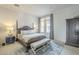 Spacious bedroom with a large bed, a bench at the foot, and an ornate wardrobe at 30 W Palm Ln, Phoenix, AZ 85003