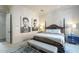 Primary bedroom with a large bed, a bench, and black and white artwork at 30 W Palm Ln, Phoenix, AZ 85003