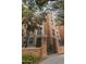 Brick building exterior with gated entrance, landscaping, and architectural details at 30 W Palm Ln, Phoenix, AZ 85003