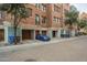 View of building exterior, garages, and parking at 30 W Palm Ln, Phoenix, AZ 85003