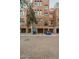 View of building exterior, garages, and parking at 30 W Palm Ln, Phoenix, AZ 85003