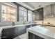 Modern kitchen with dark cabinetry, quartz countertops, and large windows at 30 W Palm Ln, Phoenix, AZ 85003