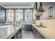 Modern kitchen with dark cabinetry, marble countertops, and a gas cooktop at 30 W Palm Ln, Phoenix, AZ 85003