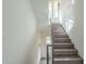 Modern staircase with wood steps and metal railings leading upstairs at 30 W Palm Ln, Phoenix, AZ 85003