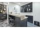 Modern wet bar with dark cabinetry and a granite countertop at 30 W Palm Ln, Phoenix, AZ 85003
