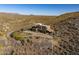 Aerial view of a house with a flat roof in desert landscape at 37300 N School House Rd, Cave Creek, AZ 85331