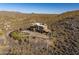 Aerial view of a house with a flat roof in desert landscape at 37300 N School House Rd, Cave Creek, AZ 85331