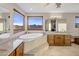 Large bathroom boasts a soaking tub, double vanity, and mountain views at 37300 N School House Rd, Cave Creek, AZ 85331