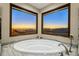 Relax in this luxurious bathroom with large windows and a soaking tub at 37300 N School House Rd, Cave Creek, AZ 85331