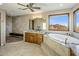 Spa-like bathroom with walk-in shower, soaking tub, and stunning views at 37300 N School House Rd, Cave Creek, AZ 85331