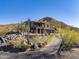 Two story house with stucco exterior, stone accents and a long driveway at 37300 N School House Rd, Cave Creek, AZ 85331
