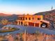 Luxury home with a large driveway, three-car garage, and desert views at 37300 N School House Rd, Cave Creek, AZ 85331