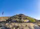 Luxury house with stone and stucco exterior, and American flag at 37300 N School House Rd, Cave Creek, AZ 85331