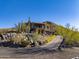Two story house with stucco exterior, stone accents and a long driveway at 37300 N School House Rd, Cave Creek, AZ 85331