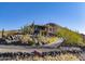 Two story house with stucco exterior, stone accents and a long driveway at 37300 N School House Rd, Cave Creek, AZ 85331