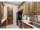Convenient laundry room with granite counters and built-in cabinetry at 37300 N School House Rd, Cave Creek, AZ 85331