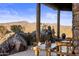 Mountain views from covered patio with wooden furniture at 37300 N School House Rd, Cave Creek, AZ 85331