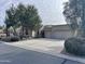 Single-story home with a two-car garage and desert landscaping at 4041 S Prairie Zinnia Dr, Gold Canyon, AZ 85118