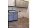 Laundry room with gray cabinets and tile floor at 4041 S Prairie Zinnia Dr, Gold Canyon, AZ 85118