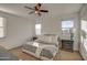 Spacious bedroom with a large bed, nightstands, and ceiling fan at 4428 N 92Nd Ln, Phoenix, AZ 85037