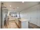 Modern kitchen with island, stainless steel appliances, and white cabinetry at 4428 N 92Nd Ln, Phoenix, AZ 85037