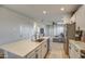 Modern kitchen features a large island with seating and stainless steel appliances at 4428 N 92Nd Ln, Phoenix, AZ 85037