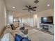 Open living space with sectional sofa, adjacent to the kitchen and dining area at 4428 N 92Nd Ln, Phoenix, AZ 85037