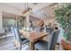 Elegant dining room with a wood table, gray chairs, and large windows at 4513 E Vista Bonita Dr, Phoenix, AZ 85050