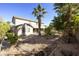 Spacious two-story backyard offering mature palm trees, desert landscaping, and gravel detail at 4615 W Corral Rd, Laveen, AZ 85339