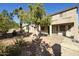 View of the backyard featuring a brick patio, xeriscaping, mature trees, and covered patio at 4615 W Corral Rd, Laveen, AZ 85339