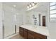 Bathroom featuring a glass-enclosed shower, dark wood vanity with sink, and a large mirror over the vanity area at 4615 W Corral Rd, Laveen, AZ 85339