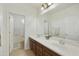 Bathroom featuring a double sink vanity, a large mirror, and a tiled floor at 4615 W Corral Rd, Laveen, AZ 85339