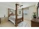 Bright bedroom featuring a canopy bed, neutral colors, and natural light from the window at 4615 W Corral Rd, Laveen, AZ 85339