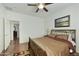 Cozy bedroom with a metal frame bed, hardwood floors, and simple decor at 4615 W Corral Rd, Laveen, AZ 85339