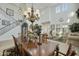 Elegant dining area featuring an ornate chandelier, a wooden dining table, and soaring ceilings at 4615 W Corral Rd, Laveen, AZ 85339