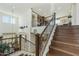 Grand foyer with wood staircase, wrought iron railings and high ceilings offering an impressive entrance to the home at 4615 W Corral Rd, Laveen, AZ 85339