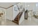 Inviting foyer with wood staircase, tile flooring, and an open floor plan leads to multiple living areas at 4615 W Corral Rd, Laveen, AZ 85339