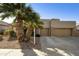 Charming home featuring desert landscaping, palm trees, and a spacious three-car driveway at 4615 W Corral Rd, Laveen, AZ 85339