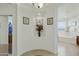 Hallway leading to bathroom and closet with white walls and tile flooring at 4615 W Corral Rd, Laveen, AZ 85339