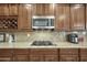 Close-up of the kitchen with granite countertops, stainless steel appliances, and wood cabinetry at 4615 W Corral Rd, Laveen, AZ 85339