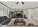 Spacious living room with dark furniture, light carpeting, and entertainment center at 4615 W Corral Rd, Laveen, AZ 85339