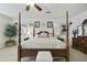 Lovely main bedroom with a four-poster bed, neutral colors, and ceiling fan at 4615 W Corral Rd, Laveen, AZ 85339