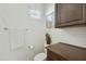 Neutral powder room features a toilet, a cabinet, a framed picture, and a window with white blinds at 4615 W Corral Rd, Laveen, AZ 85339