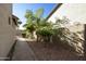 Brick pathway situated alongside the home leads to a secluded side yard with desert landscaping at 4615 W Corral Rd, Laveen, AZ 85339