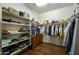 Well-organized walk-in closet with shelving and hanging rods providing ample storage space with hardwood floors at 4615 W Corral Rd, Laveen, AZ 85339