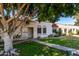 Front view of a light beige stucco house with a walkway and lawn at 5984 N 83Rd St, Scottsdale, AZ 85250